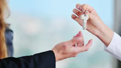 Homebuyer taking the keys from a real estate agent Homebuyer taking the keys from a real estate agent
