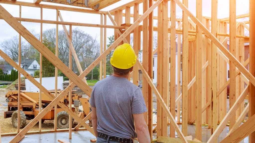 Home builder looks over work at a construction site