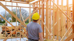 Home builder looks over work at a construction site Home builder looks over work at a construction site