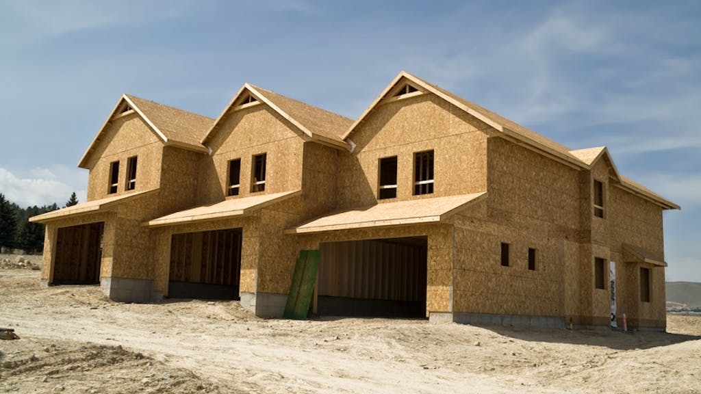 Three small townhomes under construction at the farming stage