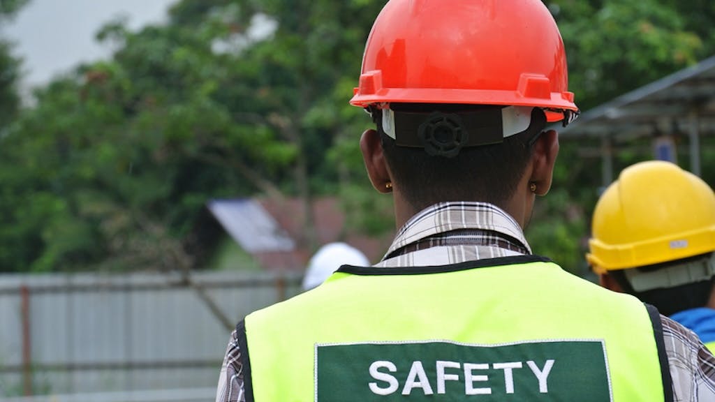 Construction worker wearing hard hat and safety vest