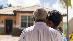 Baby Boomer couple admires Florida home Baby Boomer couple admires Florida home