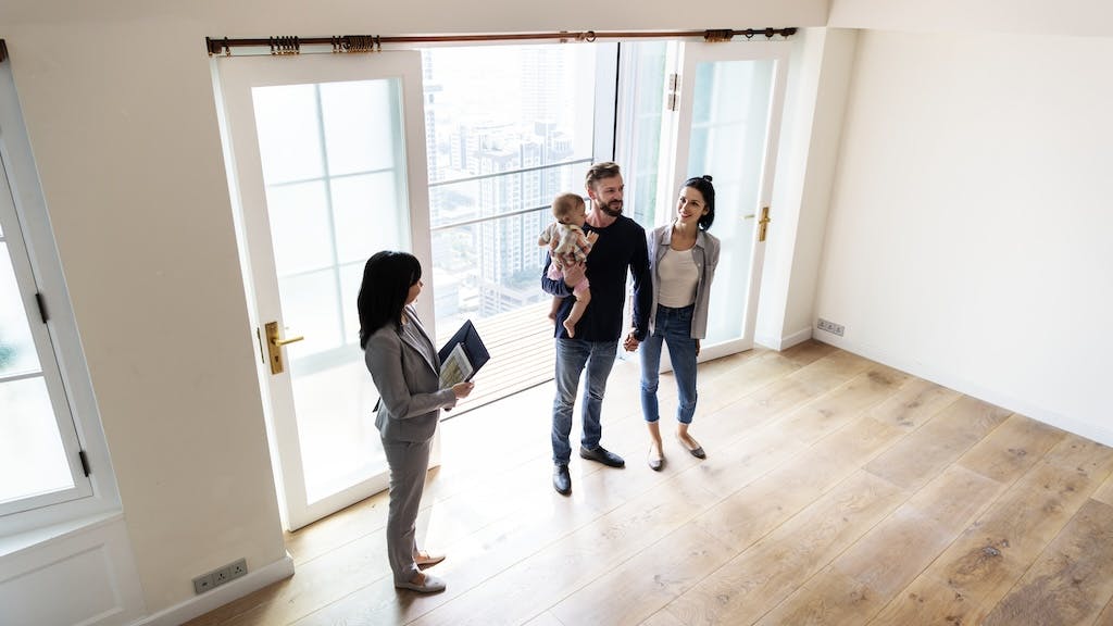 Young family tours a starter home with a real estate agent