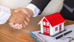 An investor shakes hands with a real estate agent after buying a home An investor shakes hands with a real estate agent after buying a home
