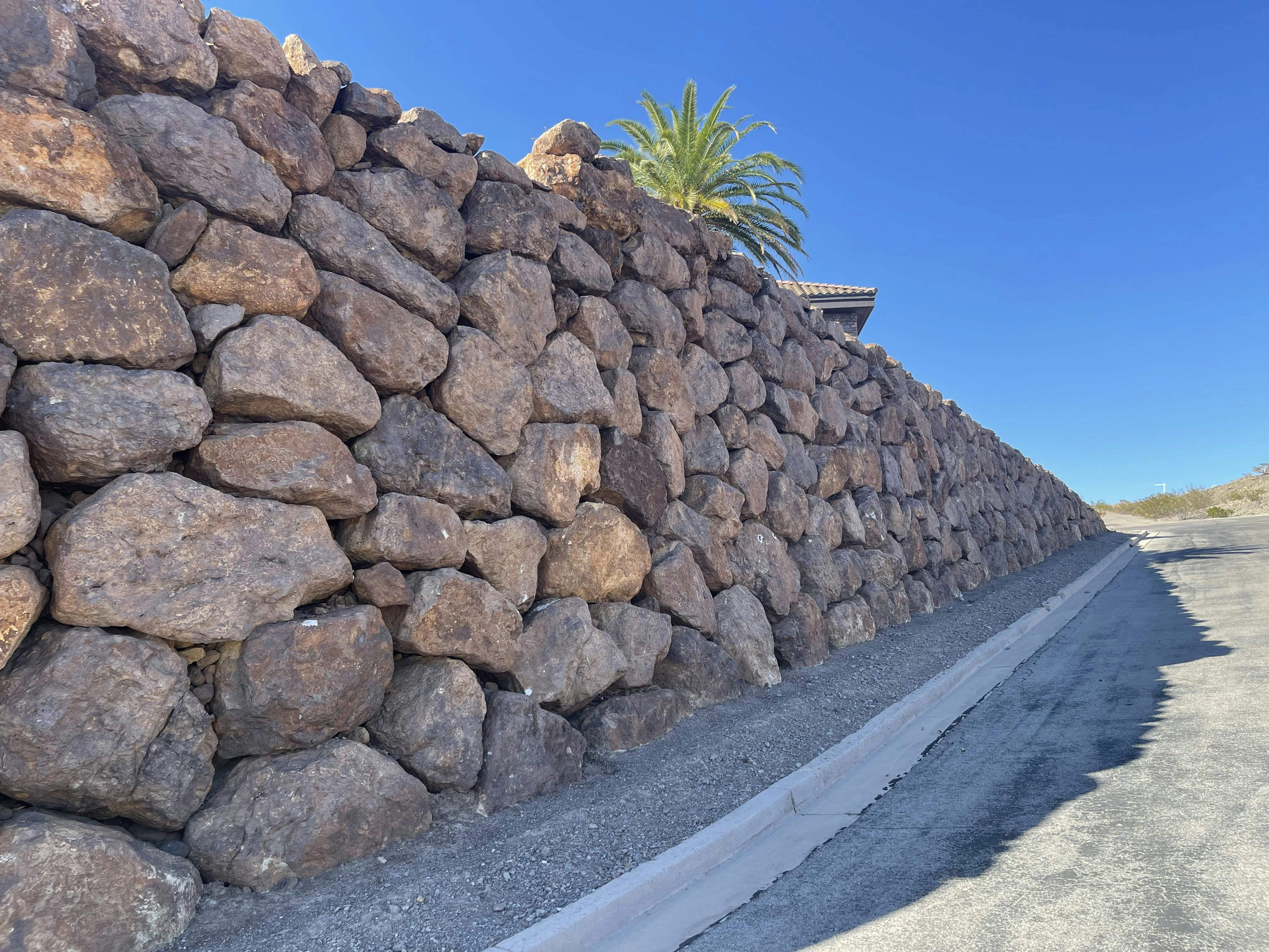Rockery walls are a popular ftrend in desert communities where blending into the landscape is an aesthetic priority.