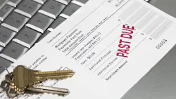 A mortgage statement sits on top of a laptop with a red stamp that reads 'Past Due' A mortgage statement sits on top of a laptop with a red stamp that reads 'Past Due'