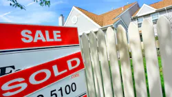 A 'sold' sign in front of a home A 'sold' sign in front of a home