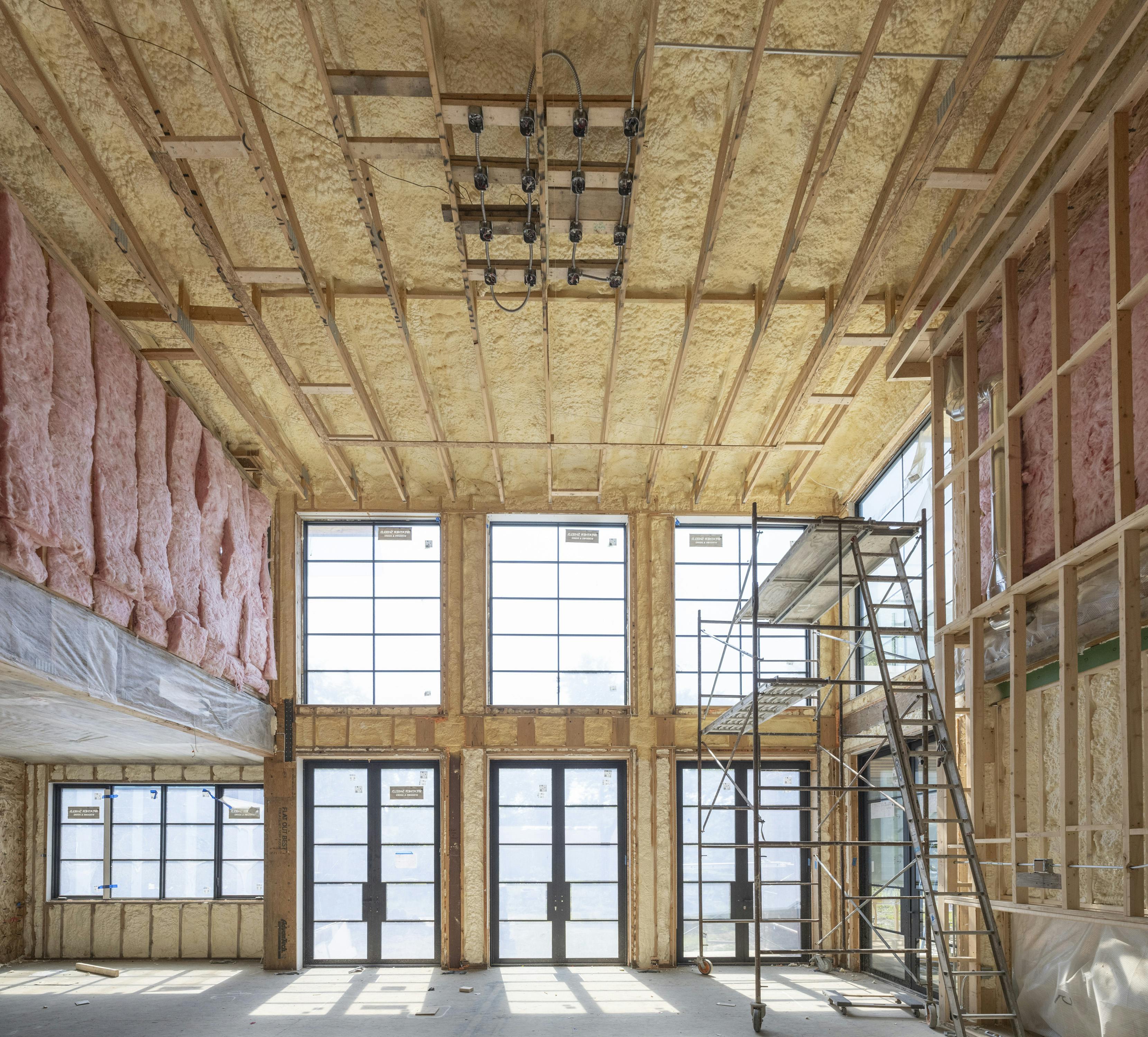 A combination of closed cell and open cell insulation achieves R-21 perimeter walls and an R-49 roof system. Batt insulation on the interior walls helps control sound transmission. Photo Credit: Michael Lipman Photography