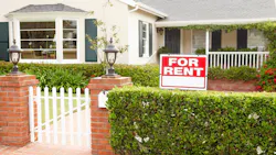 'For Rent' sign in front of a single-family home 'For Rent' sign in front of a single-family home