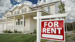 Home with a 'For Rent' sign in the front yard Home with a 'For Rent' sign in the front yard