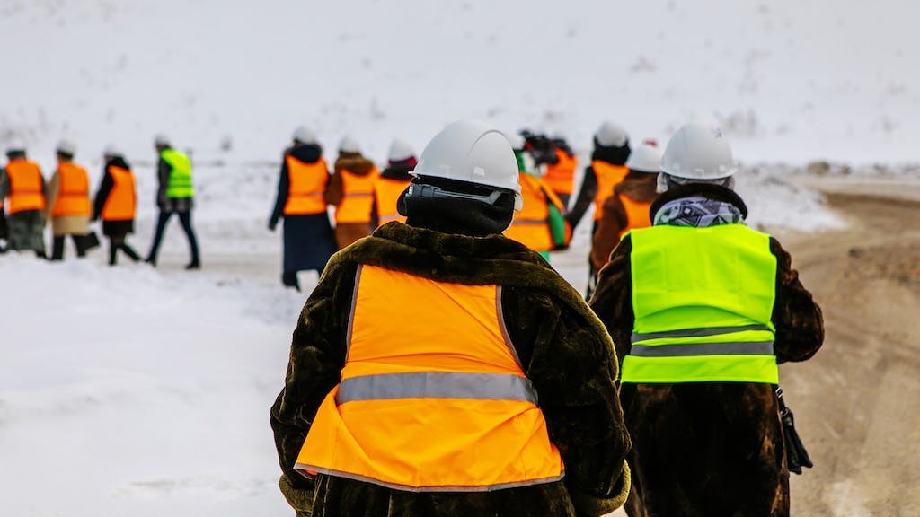 Line of construction workers walking in the snow