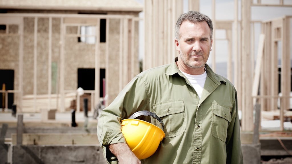 Construction worker holding a hard hat
