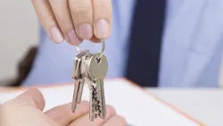 Real estate agent hands key to new homeowner Real estate agent hands key to new homeowner