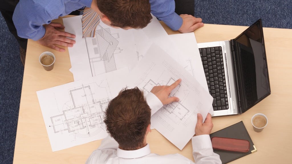 Project team going over house plans