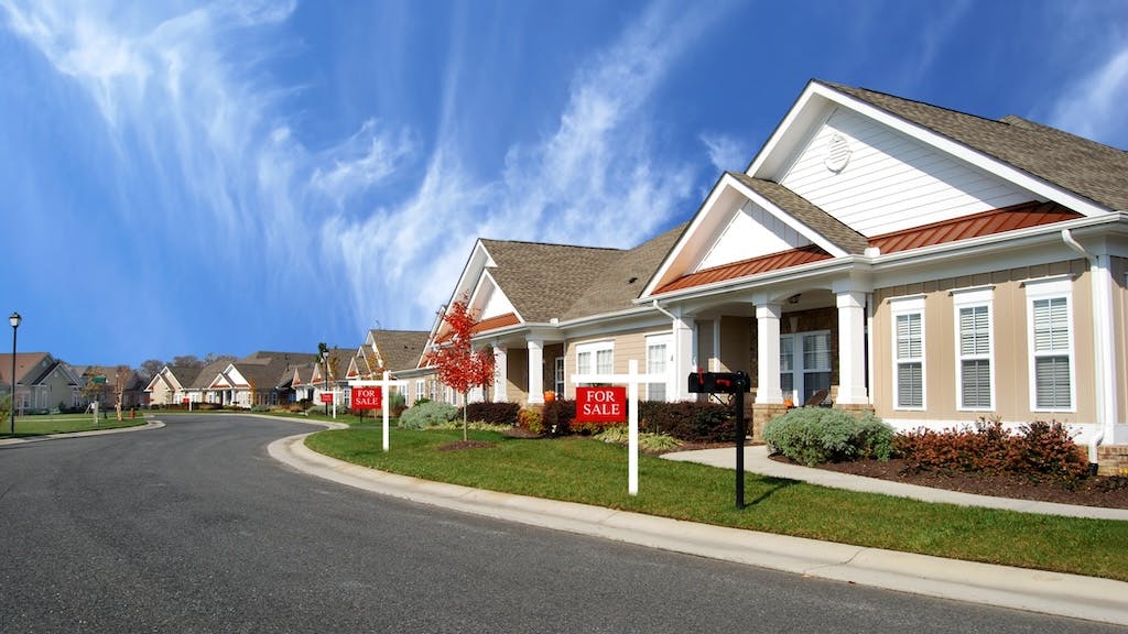 Homes with 'For Sale' signs in the front yard