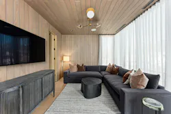 Situated upstairs, a cozy den in the guest wing provides a quiet reprieve from the main area of the home. It connects to a full bath and office beyond and is bookended by a guest suite with a terrace and lake view. Situated upstairs, a cozy den in the guest wing provides a quiet reprieve from the main area of the home. It connects to a full bath and office beyond and is bookended by a guest suite with a terrace and lake view.