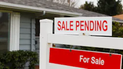 Sign posted in front yard showing a home sale is pending Sign posted in front yard showing a home sale is pending