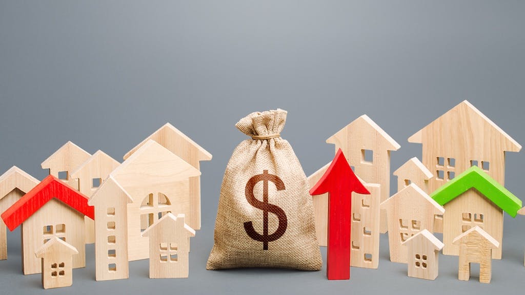 Arrow next to model homes indicating rising home prices