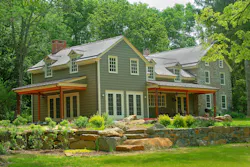 Dormers on the new addition ran through eaves, keeping its rooflines lower than Dormers on the new addition ran through eaves, keeping its rooflines lower than