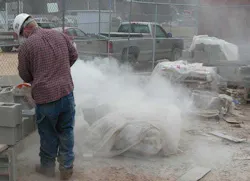 Construction worker cutting concrete block Construction worker cutting concrete block