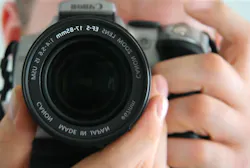 Man using 35 mm SLR camera Man using 35 mm SLR camera