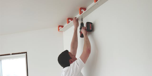 Installing the Simpliframe kit's modular, interlocking framing components.