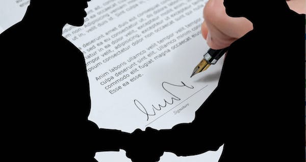 two people shaking hands in an agreement