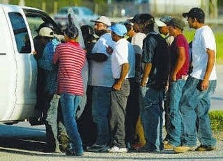 Latino workers crowd around potential hirer
