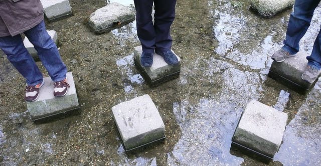taking steps to make big improvements in your business&mdash;image of standing on stepping stones