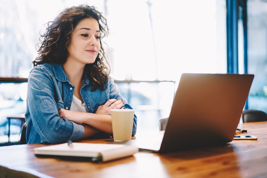 Woman looking at a webinar on her laptop
