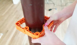 Close-up photo of the Simpliframe system being used around a pipe.