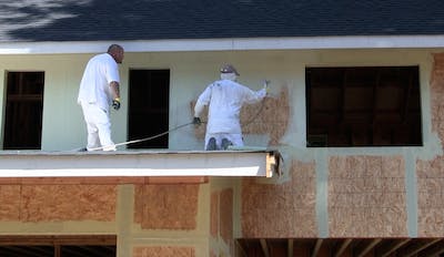 StoGuard fully adhered air and moisture barrier being applied to a wall