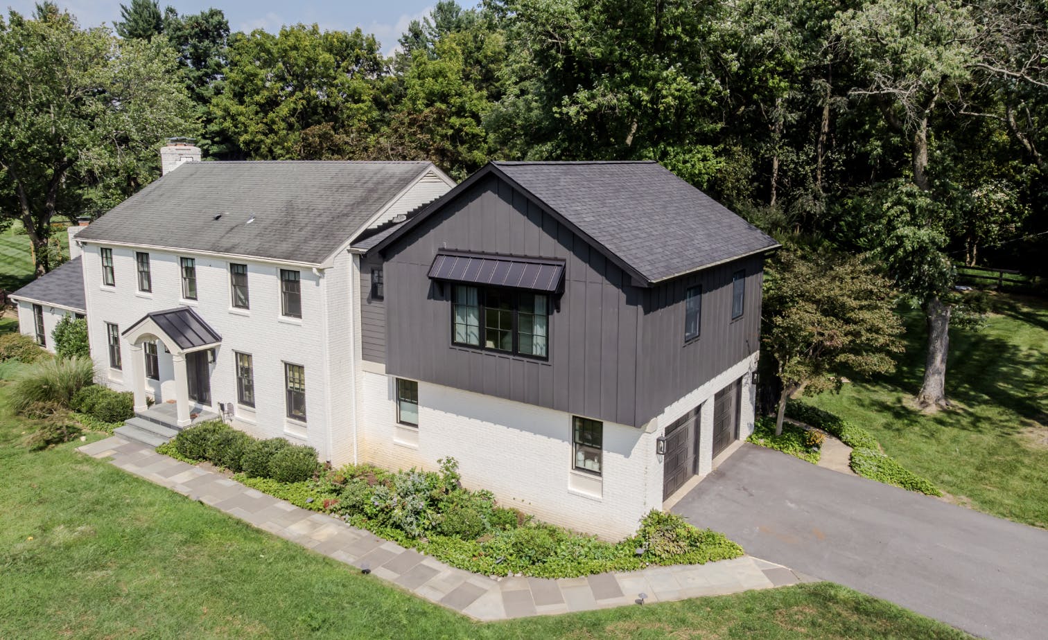 Cornerstone Remodeling added a large primary suite over their client's existing garage. The big challenge was designing the exterior so it kept the original home's charm and curb appeal. Photo: Cornerstone Remodeling.