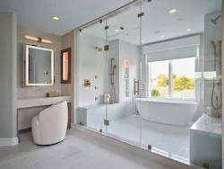Every aspect of the reimagined home exudes luxury and thoughtful design. A small shower and platform tub were replaced by a wetroom with dual shower stations, heated floors, and a soaking tub. Every aspect of the reimagined home exudes luxury and thoughtful design. A small shower and platform tub were replaced by a wetroom with dual shower stations, heated floors, and a soaking tub.