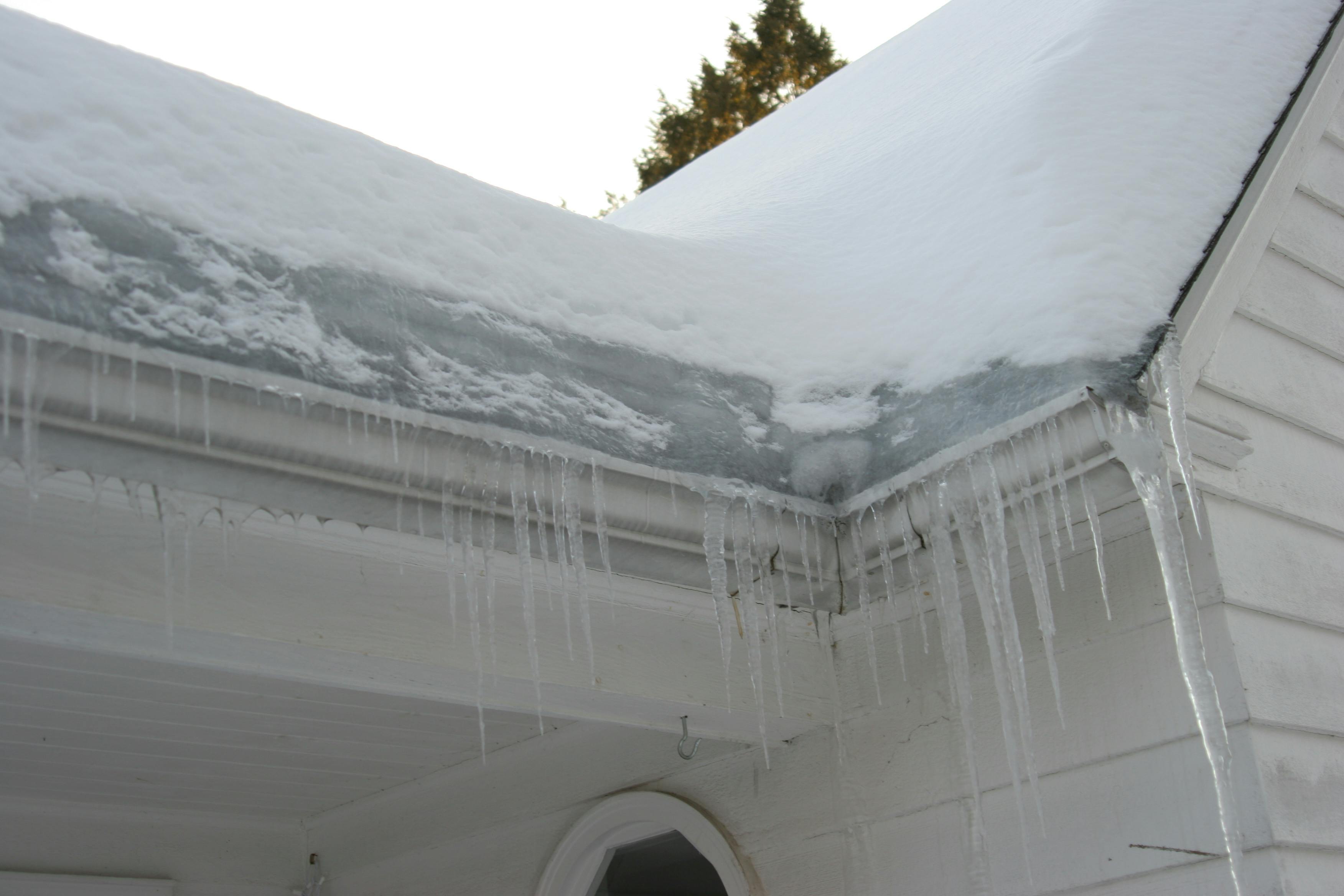 An ice dam forms on the roof of a home.