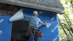 A builder installs Henry Blueskin VP100 on a house A builder installs Henry Blueskin VP100 on a house