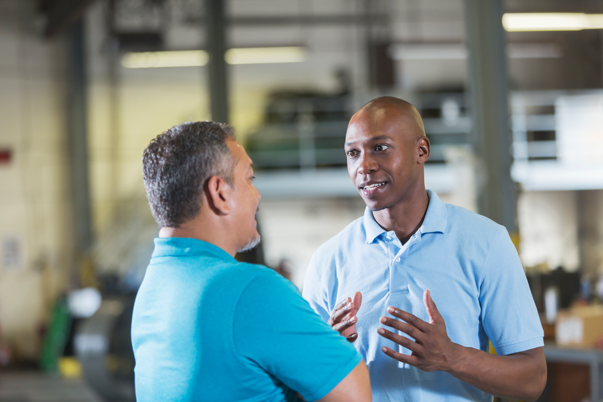 A service advisor talks with a shop owner.