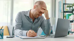 Man dealing with work-related stress. Man dealing with work-related stress.