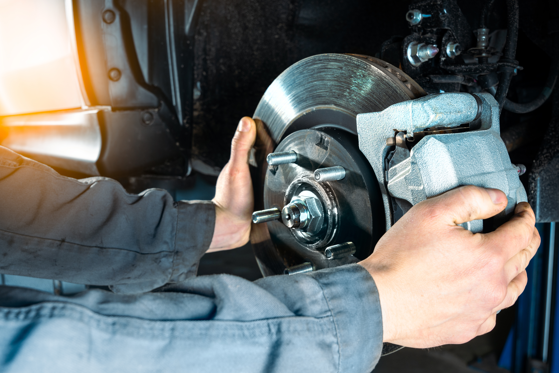 A technician working on a brake rotor.