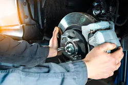 A technician working on a brake rotor. A technician working on a brake rotor.