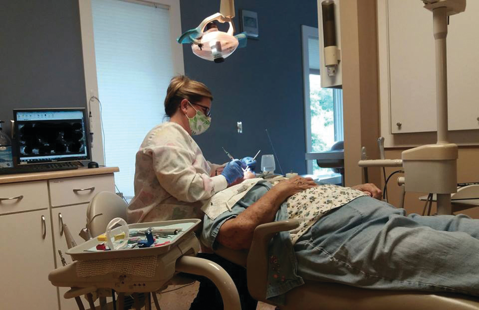 Lisa Costello, RDH, provides preventive services to a patient.