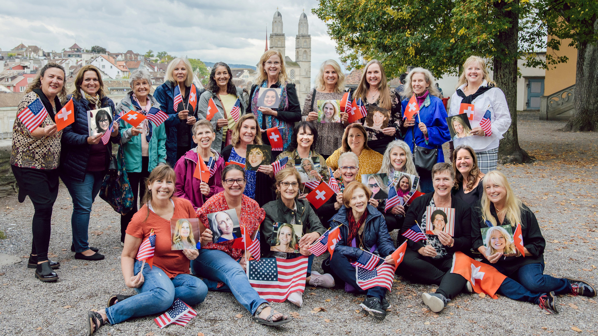 RDHs who worked in Switzerland more than 30 years ago gathered for a recent reunion in Switzerland. They're holding photos of their friends who weren't able to make the trip.