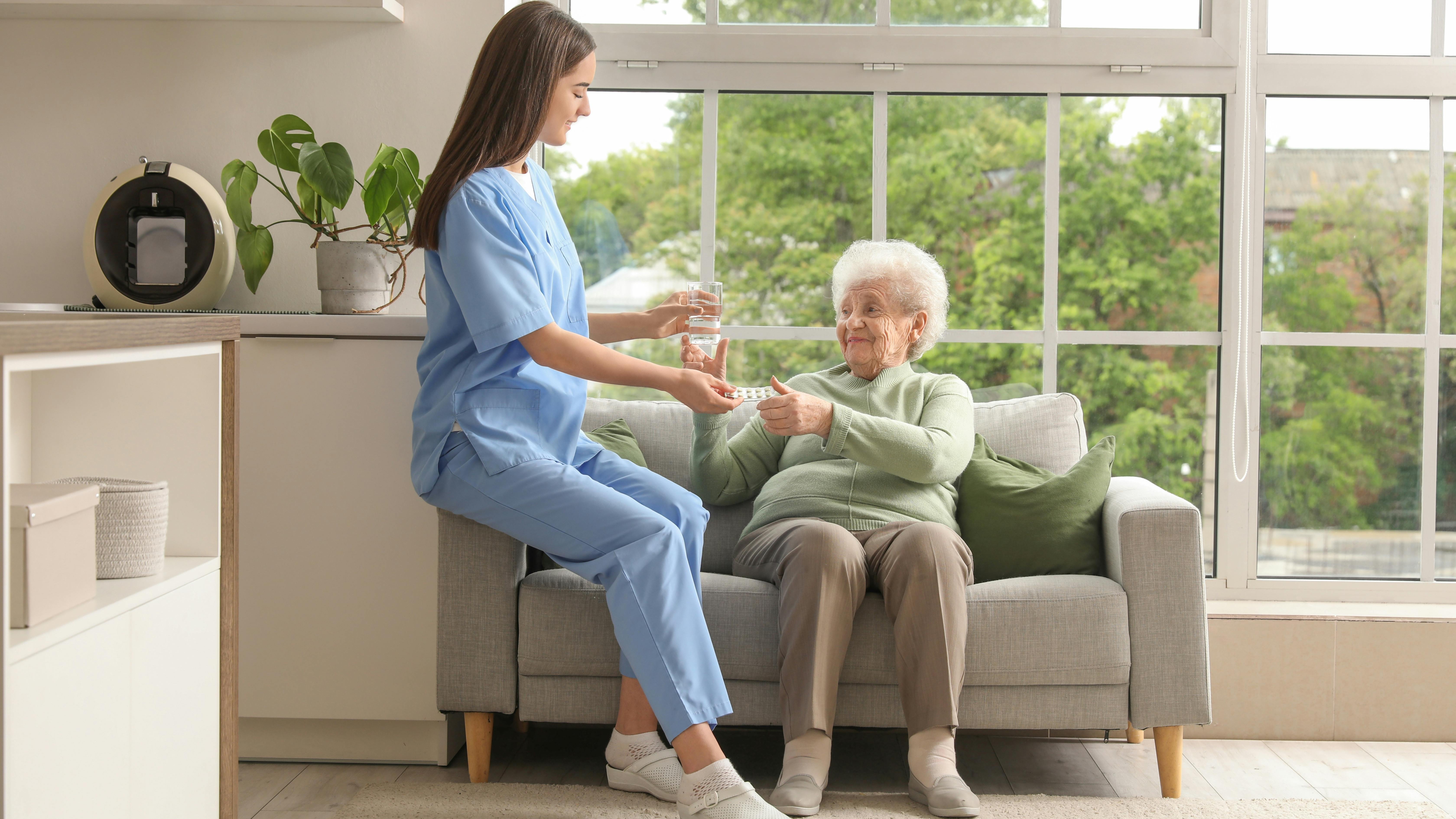 woman-giving-elderly-woman-medication