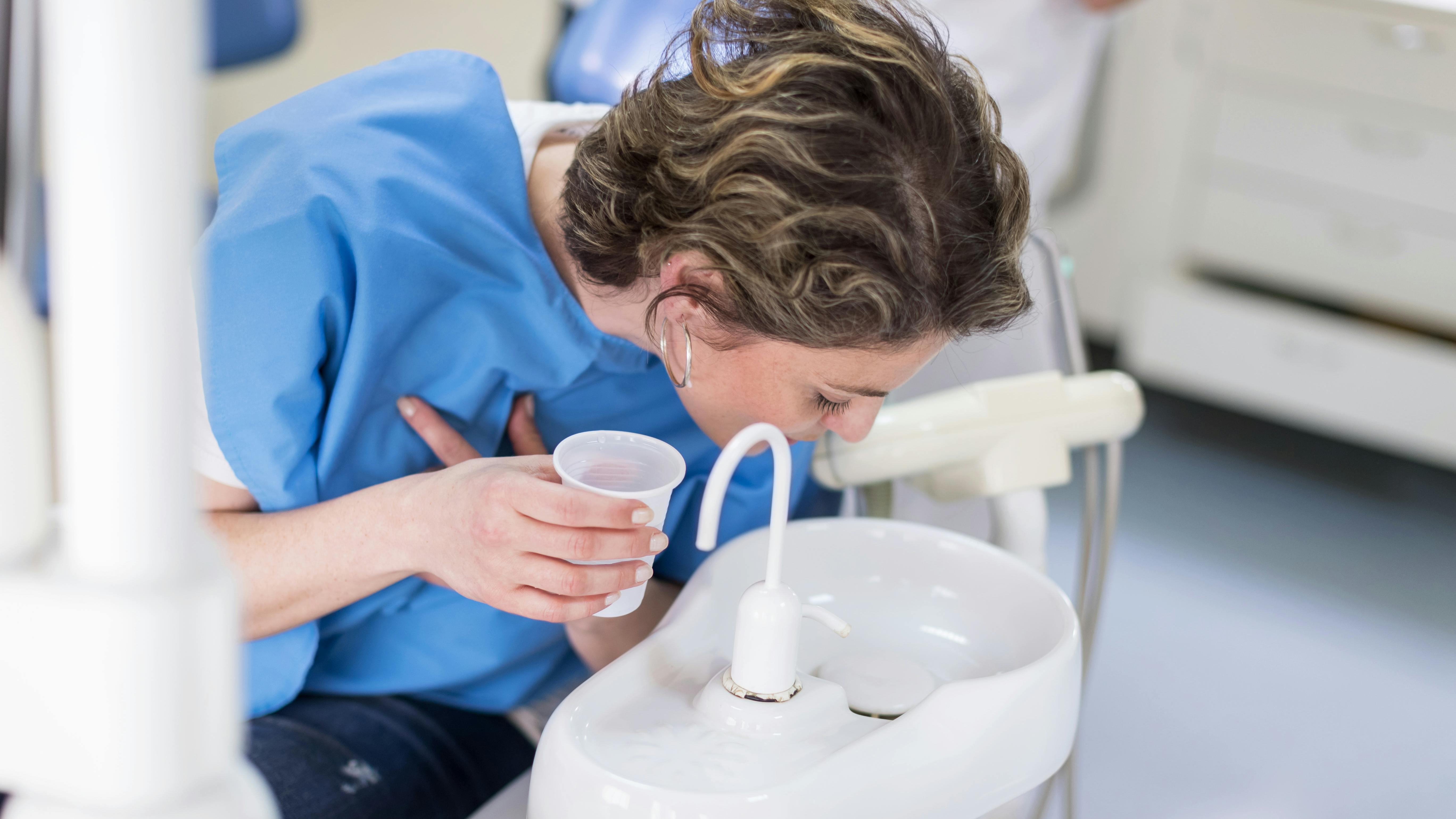 Patient using oral mouth rinse