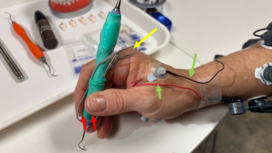 hand holding a dental instrument