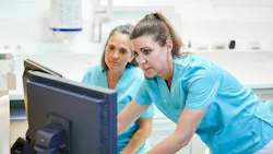 Dental hygienist and assistant reviewing patient care in operatory, illustrating oral preventive assistant role in practice Dental hygienist and assistant reviewing patient care in operatory, illustrating oral preventive assistant role in practice