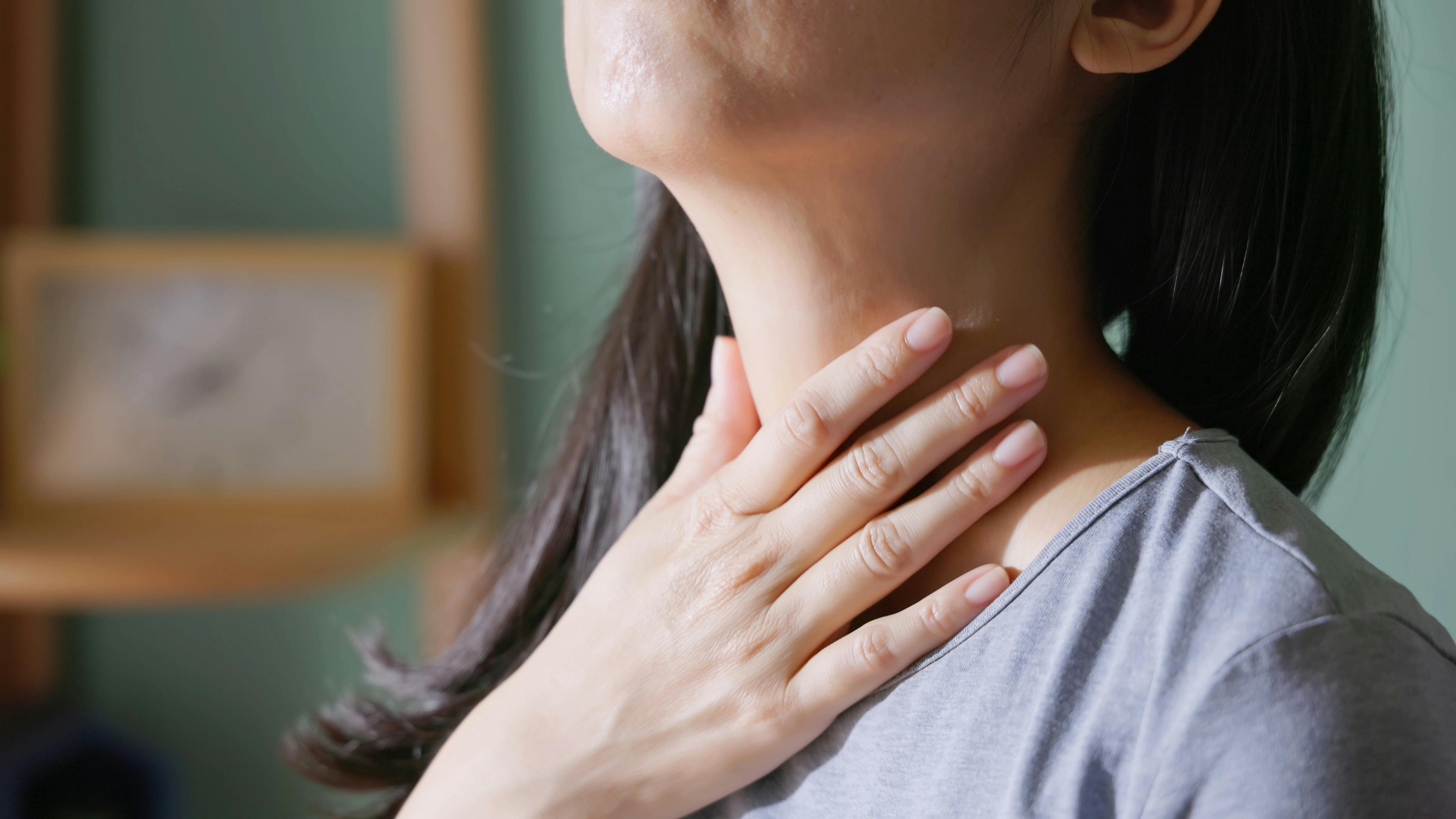 a lady with a hand on her neck