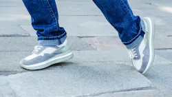 A person's feet walking over uneven pavement A person's feet walking over uneven pavement