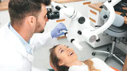 a dental professional using microscope technology on a dental patient a dental professional using microscope technology on a dental patient