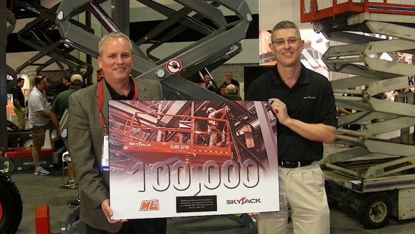Rick Dahl left of Metrolift is honored for buying the 100000th SJIII 3219 scissorlift manufactured by Skyjack At right is Skyjack president Brad Boehler Photo by Michael Roth RER